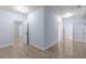 Spacious walk-in closet with multiple entryways, open shelving, and tile flooring at 1614 Rucker Rd, Alpharetta, GA 30009