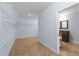 Spacious walk-in closet with shelving leading to an ensuite bathroom with dark wood cabinets at 1614 Rucker Rd, Alpharetta, GA 30009