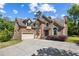 Beautiful brick home with a well-manicured lawn and a spacious driveway, featuring a two-car garage and a welcoming entrance at 1614 Rucker Rd, Alpharetta, GA 30009
