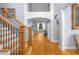 Spacious foyer showcasing hardwood floors, an elegant staircase, and an open entryway to the living areas at 1614 Rucker Rd, Alpharetta, GA 30009