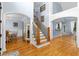 Elegant foyer featuring hardwood floors, staircase, and archway leading to the dining room at 1614 Rucker Rd, Alpharetta, GA 30009