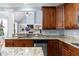 Open kitchen with wood cabinets, granite countertops, and stainless steel dishwasher at 1614 Rucker Rd, Alpharetta, GA 30009