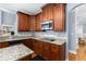 Modern kitchen with granite countertops, stainless steel appliances, and dark wood cabinets offering ample storage space at 1614 Rucker Rd, Alpharetta, GA 30009