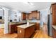 Well-designed kitchen with granite countertops, a central island, and modern appliances seamlessly flowing into the living areas at 1614 Rucker Rd, Alpharetta, GA 30009
