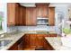 Well-equipped kitchen featuring granite countertops, stainless steel appliances, and dark wood cabinetry, perfect for cooking at 1614 Rucker Rd, Alpharetta, GA 30009