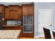 Kitchen features wooden cabinets, granite countertops and stainless steel double oven at 1614 Rucker Rd, Alpharetta, GA 30009