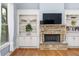Inviting living room with built-in shelving and a stone fireplace feature at 1614 Rucker Rd, Alpharetta, GA 30009