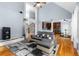 Open-concept living area with hardwood floors, stairs, and a modern kitchen at 1614 Rucker Rd, Alpharetta, GA 30009