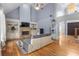 Spacious living room with a stone fireplace, built-in shelving, and hardwood floors at 1614 Rucker Rd, Alpharetta, GA 30009
