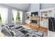Spacious living room featuring a stone fireplace, built-in shelving, and hardwood floors, filled with natural light at 1614 Rucker Rd, Alpharetta, GA 30009