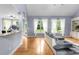 Open-concept living area with hardwood floors, large windows and access to the dining area and outdoor space at 1614 Rucker Rd, Alpharetta, GA 30009