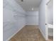 Large walk-in closet with ample shelving next to bathroom at 1614 Rucker Rd, Alpharetta, GA 30009
