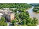 Aerial view of a condo community bordered by lush trees and a winding river at 200 River Vista Dr # 120, Atlanta, GA 30339