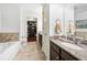 Bright bathroom with granite countertops, a soaking tub, and view to the walk-in closet at 200 River Vista Dr # 120, Atlanta, GA 30339