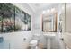 Chic powder room featuring stylish vanity, decorative mirror, and artistic wall decor at 200 River Vista Dr # 120, Atlanta, GA 30339