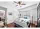 Bright guest bedroom featuring a ceiling fan, hardwood floors, a large window, and desk area at 200 River Vista Dr # 120, Atlanta, GA 30339