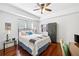Guest bedroom featuring a ceiling fan, hardwood floors, a large window, and desk area at 200 River Vista Dr # 120, Atlanta, GA 30339
