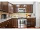 Gourmet kitchen with stainless steel appliances, granite counters, and ample cabinet space at 200 River Vista Dr # 120, Atlanta, GA 30339