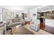 Open concept living area featuring hardwood floors, neutral sofas, and views of the dining room and kitchen at 200 River Vista Dr # 120, Atlanta, GA 30339