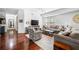 Cozy living room with hardwood floors, sofas, armchairs, a coffee table, and a tv console at 200 River Vista Dr # 120, Atlanta, GA 30339