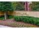 A beautifully landscaped sign for One River Place with mature trees and flowerbeds at 200 River Vista Dr # 120, Atlanta, GA 30339