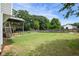 Large backyard with green grass, a tall privacy fence, and a spacious wooden deck with stairs at 259 Pine Valley Dr, Powder Springs, GA 30127