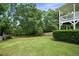 Expansive backyard with lush green grass, mature trees, and a privacy fence at 259 Pine Valley Dr, Powder Springs, GA 30127