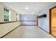 Spacious basement with white tiled floor, drop ceiling, and natural light from two windows at 259 Pine Valley Dr, Powder Springs, GA 30127