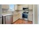 A close-up of the kitchen featuring stainless steel appliances and neutral-toned cabinets at 259 Pine Valley Dr, Powder Springs, GA 30127