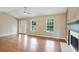 Bright living room featuring gleaming hardwood floors, a fireplace, and natural light at 259 Pine Valley Dr, Powder Springs, GA 30127