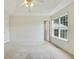 Spacious main bedroom featuring a tray ceiling, ceiling fan, and large window at 259 Pine Valley Dr, Powder Springs, GA 30127