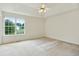 Bright main bedroom featuring a large window and a tray ceiling with fan at 259 Pine Valley Dr, Powder Springs, GA 30127