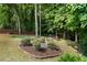 Serene backyard showcasing mature trees, a wooden fence, and a picnic area at 4321 Sugar Maple Chase Nw, Acworth, GA 30101
