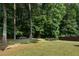 Expansive backyard with mature trees and grassy lawn at 4321 Sugar Maple Chase Nw, Acworth, GA 30101