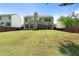 Large backyard features a grassy lawn, mature trees, patio, and a wooden privacy fence at 4321 Sugar Maple Chase Nw, Acworth, GA 30101