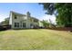 Spacious backyard featuring a grassy lawn, privacy fence, patio, and mature landscaping at 4321 Sugar Maple Chase Nw, Acworth, GA 30101
