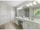 Neutral bathroom featuring double sinks, white cabinets, and a large mirror at 4321 Sugar Maple Chase Nw, Acworth, GA 30101