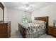 Bedroom featuring a traditional-style bed, ceiling fan, and window at 4321 Sugar Maple Chase Nw, Acworth, GA 30101