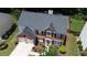 Aerial view of a red brick home with a well-manicured lawn and a two-car garage at 4321 Sugar Maple Chase Nw, Acworth, GA 30101