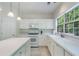 Kitchen features white cabinets, stainless steel appliances, an island, and a large window at 4321 Sugar Maple Chase Nw, Acworth, GA 30101