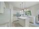 Bright kitchen with stainless steel appliances, an island, and white cabinets overlooking the backyard at 4321 Sugar Maple Chase Nw, Acworth, GA 30101