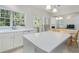 Bright kitchen features an island, white cabinets, tile floors, eat in area and view to the living room at 4321 Sugar Maple Chase Nw, Acworth, GA 30101
