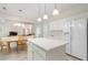 Bright kitchen features an island, white cabinets, tile floors, eat in area and view to the living room at 4321 Sugar Maple Chase Nw, Acworth, GA 30101