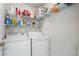 Laundry room equipped with washer, dryer, and shelving for supplies at 4321 Sugar Maple Chase Nw, Acworth, GA 30101