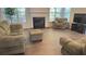 Cozy living room with hardwood floors, neutral furniture, a fireplace, and natural light at 4321 Sugar Maple Chase Nw, Acworth, GA 30101