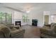 Spacious living room featuring a cozy fireplace, vaulted ceiling, and large windows at 4321 Sugar Maple Chase Nw, Acworth, GA 30101