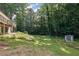 Expansive backyard with lush greenery, a shed, and partial view of the house at 4717 Westhampton Dr, Tucker, GA 30084