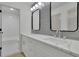 Modern bathroom featuring double sinks, quartz countertops, a sleek backsplash, and a walk-in shower at 4717 Westhampton Dr, Tucker, GA 30084