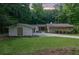 Exterior of home with well-manicured lawn and mature trees creating a private and serene setting at 4717 Westhampton Dr, Tucker, GA 30084