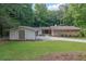 Charming single-story home with stone and brick exterior, surrounded by lush greenery and a well-manicured lawn at 4717 Westhampton Dr, Tucker, GA 30084